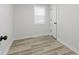A modern bedroom with light wood flooring and a window bringing in natural light at 729 S Holmes Ave, Indianapolis, IN 46221