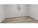 This bedroom has light gray walls, vinyl flooring, and natural light from the window at 729 S Holmes Ave, Indianapolis, IN 46221
