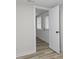 Hallway featuring modern wood-look flooring, a white front door, and neutral walls at 729 S Holmes Ave, Indianapolis, IN 46221