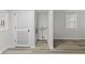 Bright hallway with modern wood-look flooring and clean, white walls at 729 S Holmes Ave, Indianapolis, IN 46221
