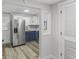 Cozy kitchen featuring stainless steel appliances and blue lower cabinets at 729 S Holmes Ave, Indianapolis, IN 46221