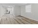 Bright living room with neutral walls and modern wood-look flooring leading to the kitchen at 729 S Holmes Ave, Indianapolis, IN 46221