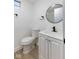 Bathroom showcasing black modern fixtures, round mirror, and white vanity at 733 S Holmes Ave, Indianapolis, IN 46221