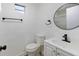 Bathroom features modern black fixtures, round mirror, and white vanity at 733 S Holmes Ave, Indianapolis, IN 46221