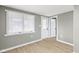 Bright bedroom featuring a window, laminate floors, freshly painted walls, and modern trim and baseboards at 733 S Holmes Ave, Indianapolis, IN 46221