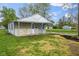Charming single-story home featuring stone accents, a covered porch, and a well maintained lawn at 733 S Holmes Ave, Indianapolis, IN 46221
