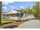 Charming single-story home featuring stone accents, a covered porch, and a gravel driveway to a shed at 733 S Holmes Ave, Indianapolis, IN 46221