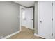 Hallway features wood-look floors, gray walls, and white trim leading to a front door with decorative glass at 733 S Holmes Ave, Indianapolis, IN 46221