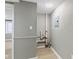 Hallway area with white trim, gray walls, laminate floors, a water heater, and access to other rooms at 733 S Holmes Ave, Indianapolis, IN 46221