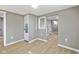 Hallway area featuring laminate floors, freshly painted walls, and modern trim and baseboards at 733 S Holmes Ave, Indianapolis, IN 46221