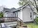This gray house has a wooden back deck with stairs down to the yard, and blue trim on the back door at 741 Walnut St, Franklin, IN 46131