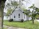 This gray house is situated on a grassy lot with mature trees, offering a peaceful and private setting at 741 Walnut St, Franklin, IN 46131