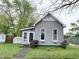 Charming gray home with tidy landscaping, inviting entrance, and Indiana Hoosiers banner in window at 741 Walnut St, Franklin, IN 46131