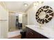 Bathroom featuring glass shower doors, modern sink, and decorative mirror at 7901 Oaklandon Rd, Indianapolis, IN 46236