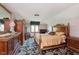 Bedroom with patterned carpet, large bed and wardrobe, and natural light from the window at 7901 Oaklandon Rd, Indianapolis, IN 46236