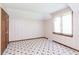 Inviting bedroom with patterned wallpaper and floral carpet, complemented by natural light from the window at 7901 Oaklandon Rd, Indianapolis, IN 46236