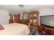 Bedroom with patterned carpet, mirrored wardrobe, and a modern TV on a wooden stand at 7901 Oaklandon Rd, Indianapolis, IN 46236