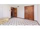 Comfortable bedroom with floral carpet, wallpaper, and a closet providing ample storage at 7901 Oaklandon Rd, Indianapolis, IN 46236
