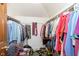 Walk-in closet featuring organized hanging clothes and a shelf with various items at 7901 Oaklandon Rd, Indianapolis, IN 46236