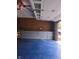 Well-organized garage with blue flooring and built-in cabinets, perfect for storage and projects at 7901 Oaklandon Rd, Indianapolis, IN 46236
