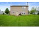 Spacious backyard showing green grass, a grill, and a firepit, perfect for relaxing and outdoor gatherings at 8211 Firefly Way, Indianapolis, IN 46259