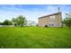 Expansive backyard featuring lush green grass and mature trees, ideal for outdoor activities and entertaining at 8211 Firefly Way, Indianapolis, IN 46259