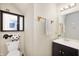 Bright bathroom featuring a black vanity, mirror and unique sheep toilet paper holder at 8211 Firefly Way, Indianapolis, IN 46259