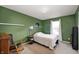 Cozy bedroom featuring green paint, carpet, and natural light from the window at 8211 Firefly Way, Indianapolis, IN 46259