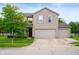 Charming two-story home with a three-car garage, well-maintained lawn, and inviting curb appeal at 8211 Firefly Way, Indianapolis, IN 46259