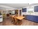 Eat-in kitchen featuring painted cabinets, hardwood floors and access to the living room at 8211 Firefly Way, Indianapolis, IN 46259