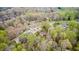 Expansive aerial view showcasing homes nestled among vibrant green trees in a tranquil neighborhood setting at 8329 S Christian Dr, Nineveh, IN 46164