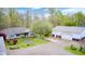 Aerial view of a home with large, gravel driveway, multiple outbuildings, and a well-maintained yard at 8329 S Christian Dr, Nineveh, IN 46164