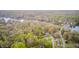 Scenic aerial perspective highlighting homes in a lush, tree-filled setting near a tranquil lake at 8329 S Christian Dr, Nineveh, IN 46164