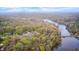 Overhead aerial view of houses nestled amongst dense trees along a river and lake, with natural beauty at 8329 S Christian Dr, Nineveh, IN 46164