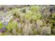 Aerial view of a house nestled amongst mature trees with outbuildings and lush greenery at 8329 S Christian Dr, Nineveh, IN 46164
