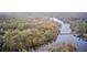 Overhead aerial view of residential area among lush trees near a tranquil lake, showing stunning natural landscape at 8329 S Christian Dr, Nineveh, IN 46164