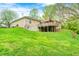 View of backyard featuring brick home, wooden deck, and green lawn at 8329 S Christian Dr, Nineveh, IN 46164