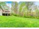 Green backyard featuring a grass lawn, mature trees and a deck area at 8329 S Christian Dr, Nineveh, IN 46164