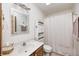 Bright bathroom featuring a decorative mirror, wood vanity, and shower with white curtain at 8329 S Christian Dr, Nineveh, IN 46164