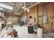 Spacious garage interior with exposed beams, storage shelving, and lighting at 8329 S Christian Dr, Nineveh, IN 46164
