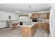 Cozy kitchen featuring wood cabinetry, an island cooktop, and an adjacent dining area at 8329 S Christian Dr, Nineveh, IN 46164