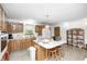 Traditional eat-in kitchen features a center island with breakfast bar and wooden cabinetry at 8329 S Christian Dr, Nineveh, IN 46164