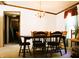 A dining room with a wooden table, chairs, chandelier, and natural light from the window at 9067 Old Haggard Rd, Morgantown, IN 46160