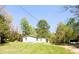 Quaint home with a bright exterior and large yard surrounded by lush trees at 9067 Old Haggard Rd, Morgantown, IN 46160