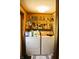 Efficient laundry area with washer, dryer, storage shelf, and hanging rack for your garments at 9067 Old Haggard Rd, Morgantown, IN 46160