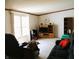 The living room includes sofas, a tv and shelving unit and a large window at 9067 Old Haggard Rd, Morgantown, IN 46160