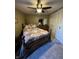 Cozy bedroom with ceiling fan, closet and decorative bedding creates an inviting retreat at 9415 Timber View Dr, Indianapolis, IN 46250