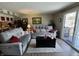 Inviting living room featuring cozy sofas, a dark coffee table, and sliding doors to an outdoor area at 9415 Timber View Dr, Indianapolis, IN 46250