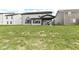 Expansive backyard featuring lush lawn, with the view of a covered patio and well-designed home exterior at 9920 Deep Royal Way, Indianapolis, IN 46239