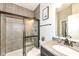 Modern bathroom featuring tiled walls, glass-enclosed shower, and vanity with sink at 9920 Deep Royal Way, Indianapolis, IN 46239